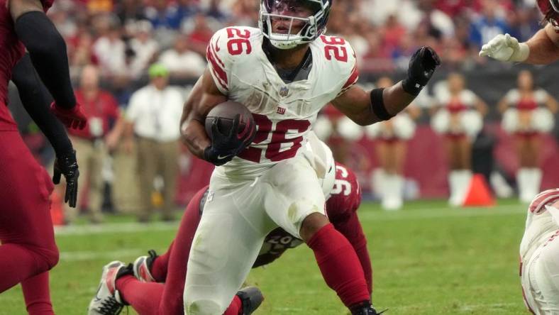 New York Giants running back Saquon Barkley (26) runs the ball against the Arizona Cardinals at State Farm Stadium in Glendale on Sept. 17, 2023.