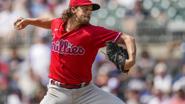 Sep 20, 2023; Cumberland, Georgia, USA; Philadelphia Phillies starting pitcher Aaron Nola (27) pitches against the Atlanta Braves during the first inning  at Truist Park. Mandatory Credit: Dale Zanine-USA TODAY Sports