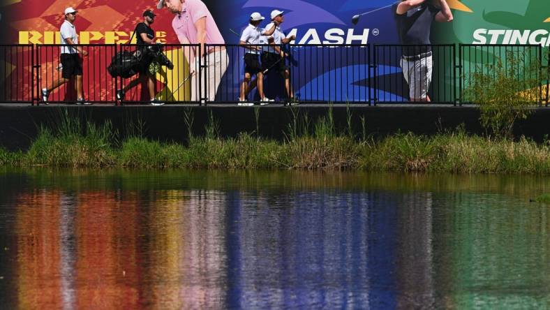 Sep 23, 2023; Sugar Grove, Illinois, USA; Sihwan Kim (far left) and James Piot and Phil Mickelson cross a bridge to the 17th green during the second round of the LIV Golf Chicago golf tournament at Rich Harvest Farms. Mandatory Credit: Jamie Sabau-USA TODAY Sports