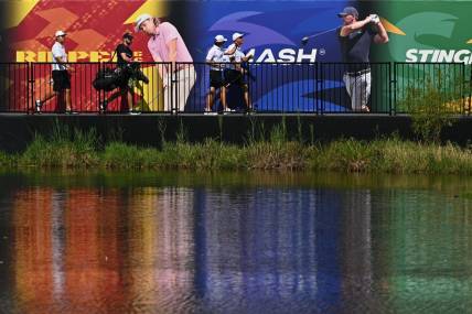 Sep 23, 2023; Sugar Grove, Illinois, USA; Sihwan Kim (far left) and James Piot and Phil Mickelson cross a bridge to the 17th green during the second round of the LIV Golf Chicago golf tournament at Rich Harvest Farms. Mandatory Credit: Jamie Sabau-USA TODAY Sports