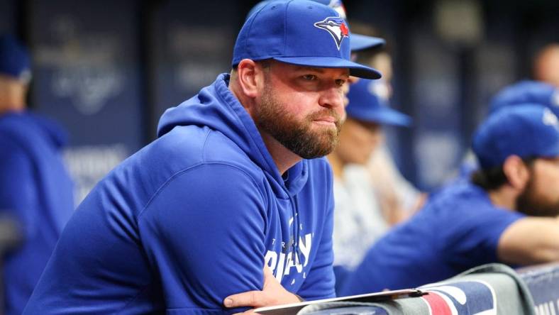 Sep 23, 2023; St. Petersburg, Florida, USA; Toronto Blue Jays manager John Schneider (14) looks on from the dugout against the Tampa Bay Rays in the eighth inning at Tropicana Field. Mandatory Credit: Nathan Ray Seebeck-USA TODAY Sports