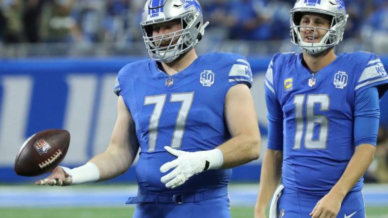 Detroit Lions quarterback Jared Goff (16) and center Frank Ragnow (77) warm up before action against the Atlanta Falcons at Ford Field, Sunday, Sept. 24, 2023.