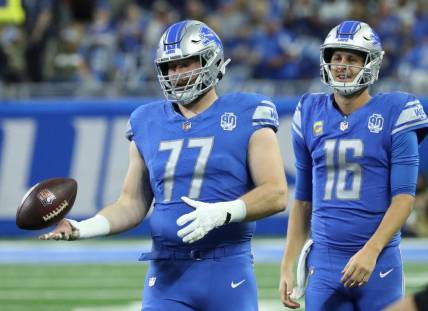 Detroit Lions quarterback Jared Goff (16) and center Frank Ragnow (77) warm up before action against the Atlanta Falcons at Ford Field, Sunday, Sept. 24, 2023.
