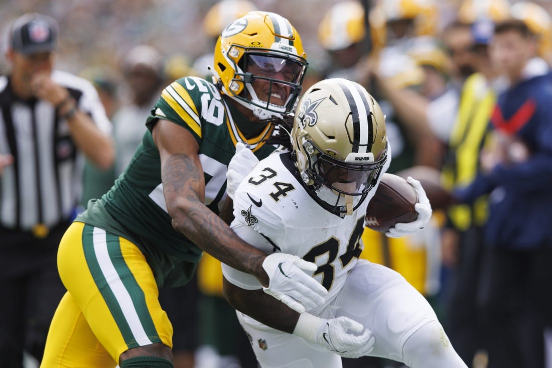 Sep 24, 2023; Green Bay, Wisconsin, USA;  New Orleans Saints running back Tony Jones Jr. (34) is tackled by Green Bay Packers cornerback Rasul Douglas (29) during the first quarter at Lambeau Field. Mandatory Credit: Jeff Hanisch-USA TODAY Sports