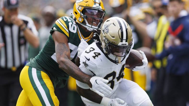 Sep 24, 2023; Green Bay, Wisconsin, USA;  New Orleans Saints running back Tony Jones Jr. (34) is tackled by Green Bay Packers cornerback Rasul Douglas (29) during the first quarter at Lambeau Field. Mandatory Credit: Jeff Hanisch-USA TODAY Sports