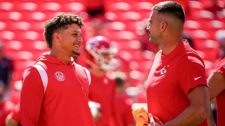 Sep 24, 2023; Kansas City, Missouri, USA; Kansas City Chiefs quarterback Patrick Mahomes (15) laughs with tight end Travis Kelce (87) against the Chicago Bears prior to a game at GEHA Field at Arrowhead Stadium. Mandatory Credit: Denny Medley-USA TODAY Sports