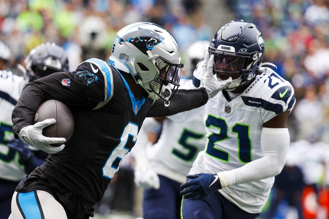 Sep 24, 2023; Seattle, Washington, USA; Carolina Panthers running back Miles Sanders (6) stiff-arms away from a tackle attempt by Seattle Seahawks cornerback Devon Witherspoon (21) during the second quarter at Lumen Field. Mandatory Credit: Joe Nicholson-USA TODAY Sports