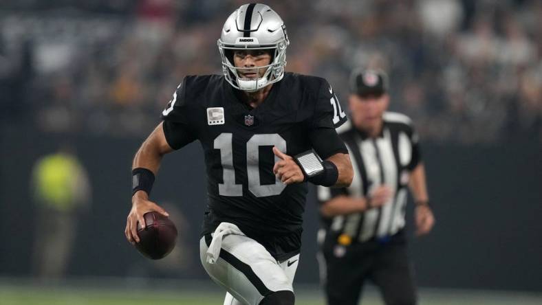 Sep 24, 2023; Paradise, Nevada, USA; Las Vegas Raiders quarterback Jimmy Garoppolo (10) carries the ball against the Pittsburgh Steelers in the second half at Allegiant Stadium. Mandatory Credit: Kirby Lee-USA TODAY Sports