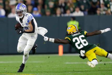 Detroit Lions wide receiver Amon-Ra St. Brown (14) gets past a tackle attempt by Green Bay Packers safety Darnell Savage (26) during their football game Thursday, September 28, 2023, at Lambeau Field in Green Bay, Wis. 
Dan Powers/USA TODAY NETWORK-Wisconsin.