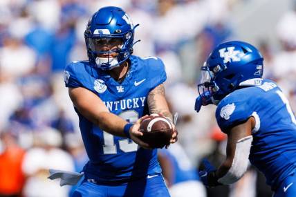 Sep 30, 2023; Lexington, Kentucky, USA; Kentucky Wildcats quarterback Devin Leary (13) hands the ball to running back Ray Davis (1) during the second quarter against the Florida Gators at Kroger Field. Mandatory Credit: Jordan Prather-USA TODAY Sports