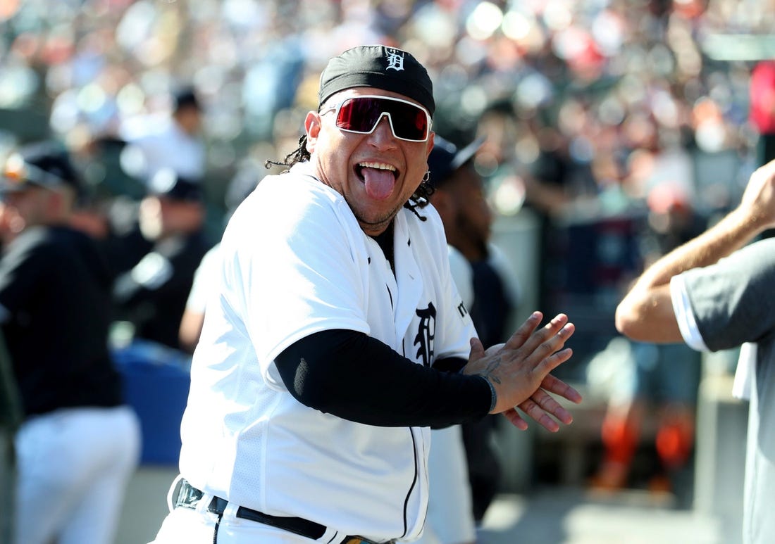 Detroit Tigers designated hitter Miguel Cabrera (24) jokes with a fan in the dugout during action against the Cleveland Guardians at Comerica Park in Detroit on Saturday, Sept. 30, 2023.