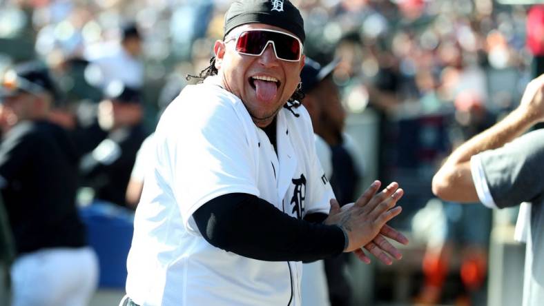 Detroit Tigers designated hitter Miguel Cabrera (24) jokes with a fan in the dugout during action against the Cleveland Guardians at Comerica Park in Detroit on Saturday, Sept. 30, 2023.