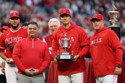 Sep 30, 2023; Anaheim, California, USA; Los Angeles Angels two-way player Shohei Ohtani (center) stands on the field with the Angels team MVP Award along with General Manager Perry Minasian (left) and Manager Phil Nevin (right) before the MLB baseball game against the Oakland Athletics at Angel Stadium. Mandatory Credit: Kiyoshi Mio-USA TODAY Sports