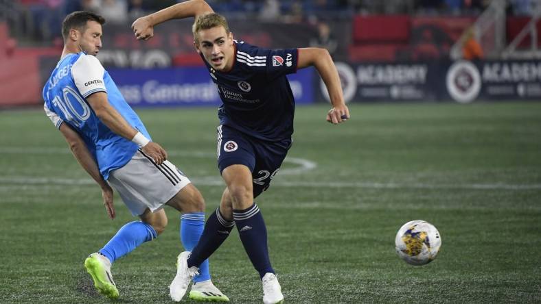 Sep 30, 2023; Foxborough, Massachusetts, USA;  Charlotte FC midfielder Brecht Dejaegere (10) and New England Revolution midfielder Noel Buck (29) battle for the ball during the first half at Gillette Stadium. Mandatory Credit: Bob DeChiara-USA TODAY Sports