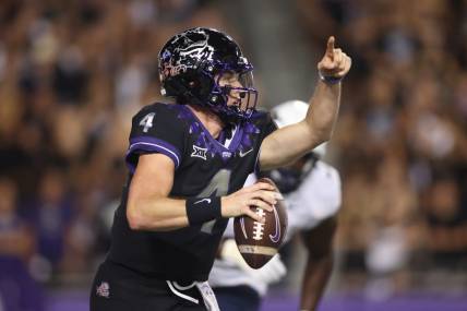 Sep 30, 2023; Fort Worth, Texas, USA; TCU Horned Frogs quarterback Chandler Morris (4) rolls out to pass against West Virginia Mountaineers defensive lineman Tomiwa Durojaiye (3) in the second quarter at Amon G. Carter Stadium. Mandatory Credit: Tim Heitman-USA TODAY Sports