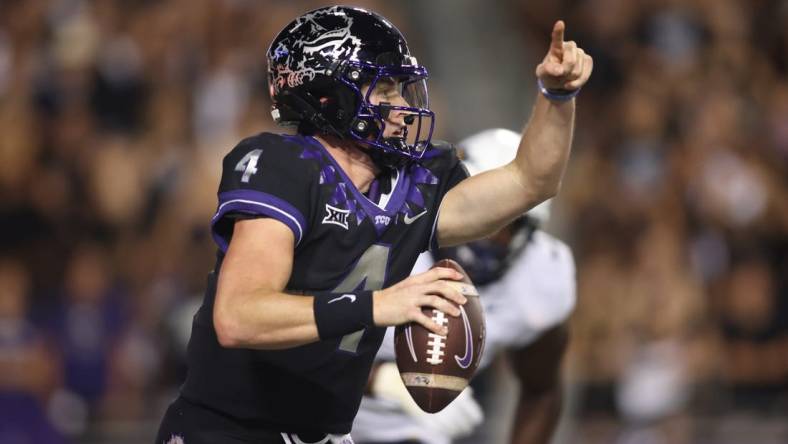 Sep 30, 2023; Fort Worth, Texas, USA; TCU Horned Frogs quarterback Chandler Morris (4) rolls out to pass against West Virginia Mountaineers defensive lineman Tomiwa Durojaiye (3) in the second quarter at Amon G. Carter Stadium. Mandatory Credit: Tim Heitman-USA TODAY Sports