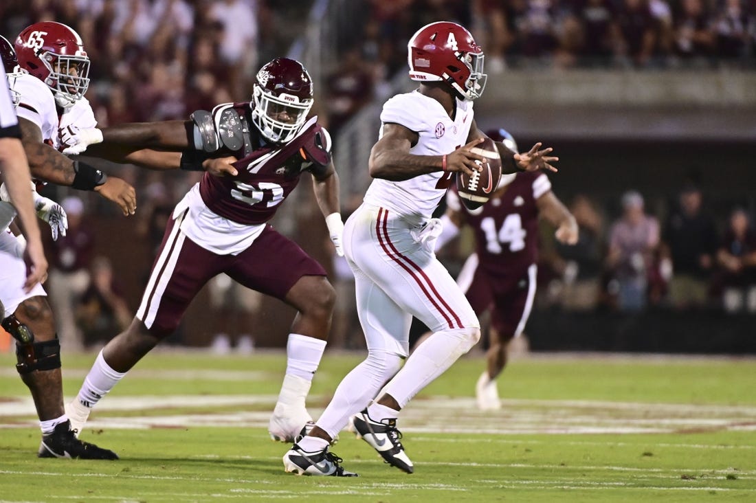 Sep 30, 2023; Starkville, Mississippi, USA; Alabama Crimson Tide quarterback Jalen Milroe (4) moves in the pocket while defended by Mississippi State Bulldogs defensive end Deonte Anderson (91) during the second quarter at Davis Wade Stadium at Scott Field. Mandatory Credit: Matt Bush-USA TODAY Sports