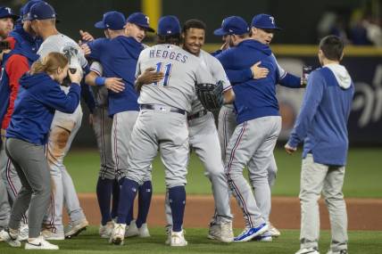 Sep 30, 2023; Seattle, Washington, USA; Texas Rangers relief pitcher Jose Leclerc (25), fourth from right, hugs catcher Austin Hedges (11) after a game against the Seattle Mariners at T-Mobile Park. Mandatory Credit: Stephen Brashear-USA TODAY Sports