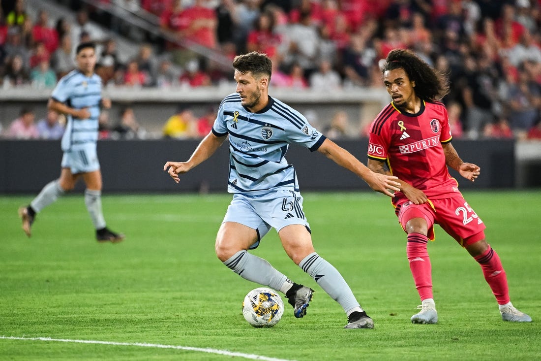 Sep 30, 2023; St. Louis, Missouri, USA; Sporting Kansas City midfielder Nemanja Radoja (6) shields the ball from St. Louis City midfielder Aziel Jackson (25) during the second half at CITYPARK. Mandatory Credit: Joe Puetz-USA TODAY Sports