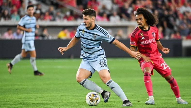 Sep 30, 2023; St. Louis, Missouri, USA; Sporting Kansas City midfielder Nemanja Radoja (6) shields the ball from St. Louis City midfielder Aziel Jackson (25) during the second half at CITYPARK. Mandatory Credit: Joe Puetz-USA TODAY Sports