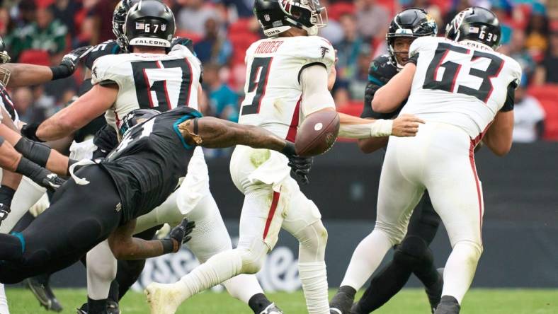 Oct 1, 2023; London, United Kingdom; Jacksonville Jaguars linebacker Josh Allen (41) pressures Atlanta Falcons quarterback Desmond Ridder (9) during the second half of an NFL International Series game at Wembley Stadium. Mandatory Credit: Peter van den Berg-USA TODAY Sports