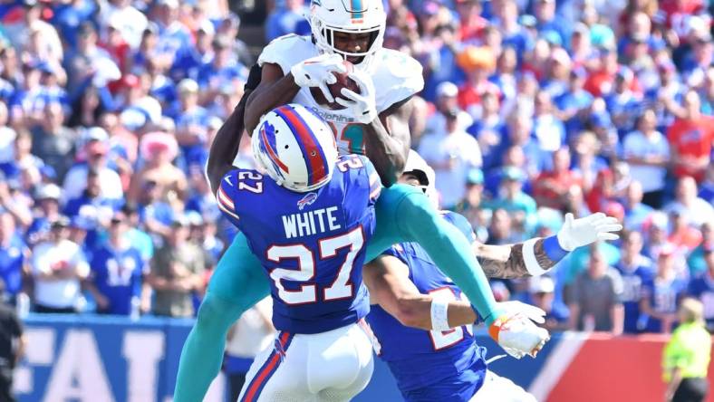 Oct 1, 2023; Orchard Park, New York, USA; Miami Dolphins running back Raheem Mostert (31) makes a catch in as Buffalo Bills cornerback Tre'Davious White (27) defends in the second quarter at Highmark Stadium. Mandatory Credit: Mark Konezny-USA TODAY Sports