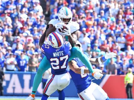 Oct 1, 2023; Orchard Park, New York, USA; Miami Dolphins running back Raheem Mostert (31) makes a catch in as Buffalo Bills cornerback Tre'Davious White (27) defends in the second quarter at Highmark Stadium. Mandatory Credit: Mark Konezny-USA TODAY Sports