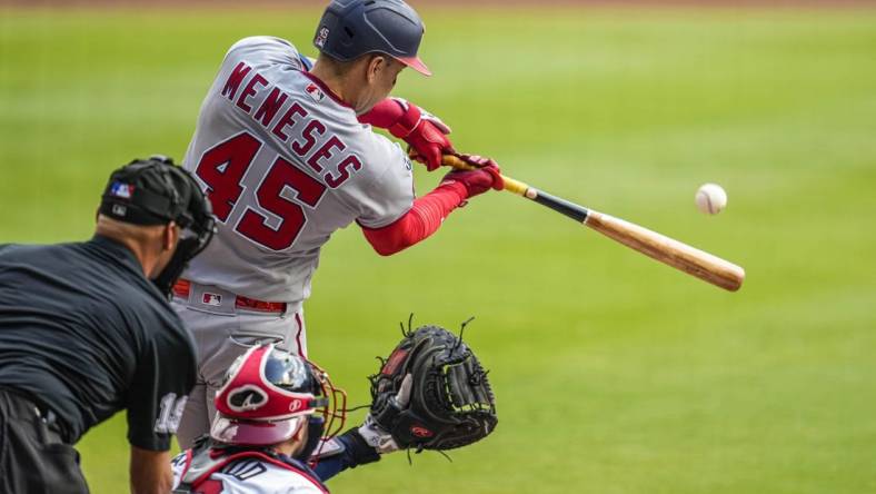 Oct 1, 2023; Cumberland, Georgia, USA; Washington Nationals first baseman Joey Meneses (45) hits a double to drive in a run against the Atlanta Braves during the first inning at Truist Park. Mandatory Credit: Dale Zanine-USA TODAY Sports