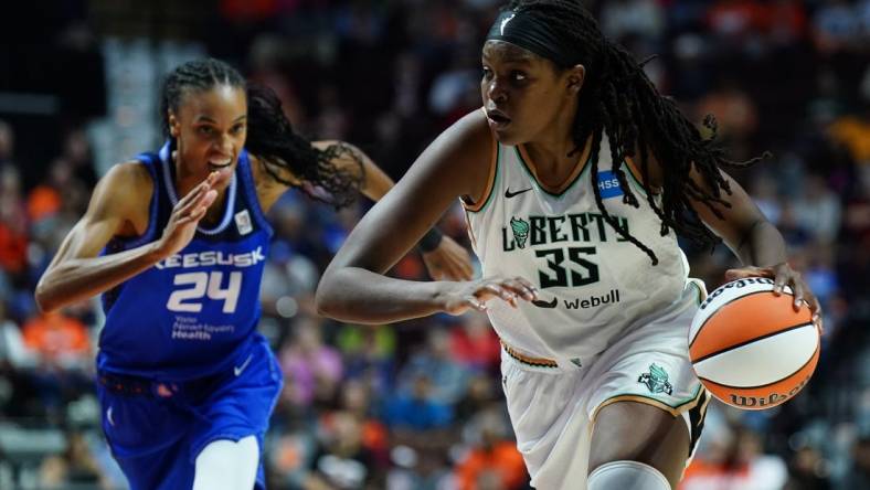 Oct 1, 2023; Uncasville, Connecticut, USA; New York Liberty forward Jonquel Jones (35) drives the ball against Connecticut Sun forward DeWanna Bonner (24) in the first half during game four of the 2023 WNBA Playoffs at Mohegan Sun Arena. Mandatory Credit: David Butler II-USA TODAY Sports