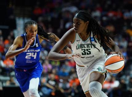 Oct 1, 2023; Uncasville, Connecticut, USA; New York Liberty forward Jonquel Jones (35) drives the ball against Connecticut Sun forward DeWanna Bonner (24) in the first half during game four of the 2023 WNBA Playoffs at Mohegan Sun Arena. Mandatory Credit: David Butler II-USA TODAY Sports