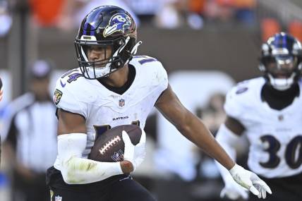 Oct 1, 2023; Cleveland, Ohio, USA; Baltimore Ravens safety Kyle Hamilton (14) runs after intercepting a pass in the fourth quarter against the Cleveland Browns at Cleveland Browns Stadium. Mandatory Credit: David Richard-USA TODAY Sports