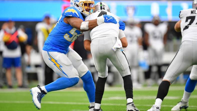 Oct 1, 2023; Inglewood, California, USA; Los Angeles Chargers linebacker Khalil Mack (52) sacks Las Vegas Raiders quarterback Aidan O'Connell (4) during the first half at SoFi Stadium. Mandatory Credit: Gary A. Vasquez-USA TODAY Sports