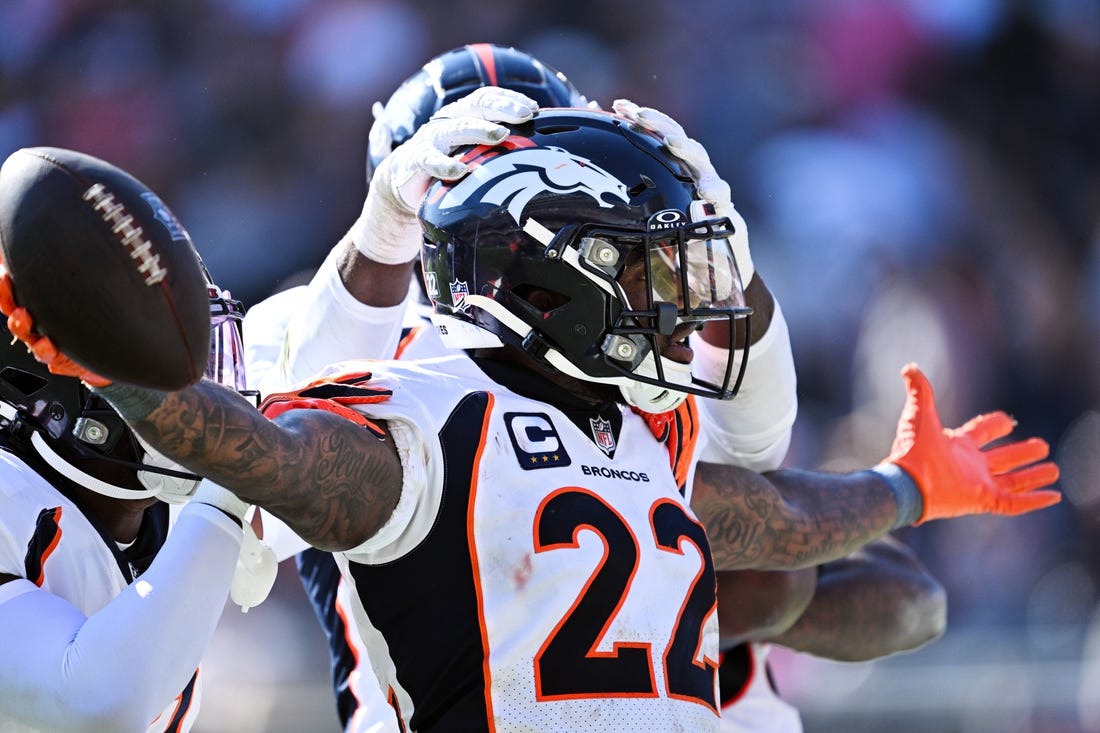 Oct 1, 2023; Chicago, Illinois, USA;  Denver Broncos safety Kareem Jackson (22) celebrates after intercepting a Chicago Bears pass in the fourth quarter at Soldier Field. Mandatory Credit: Jamie Sabau-USA TODAY Sports