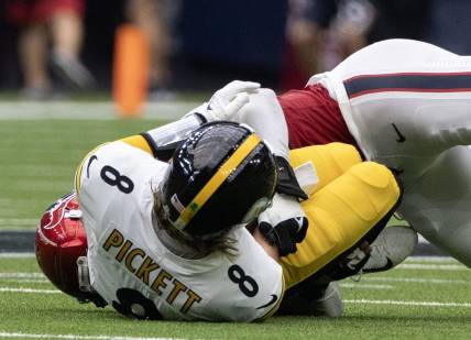 Oct 1, 2023; Houston, Texas, USA; Pittsburgh Steelers quarterback Kenny Pickett (8) is injured as he is sacked by Houston Texans defensive end Jonathan Greenard (52) in the second half at NRG Stadium. Mandatory Credit: Thomas Shea-USA TODAY Sports
