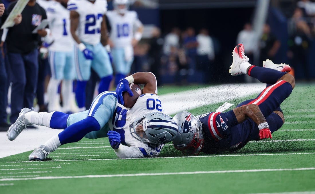 Oct 1, 2023; Arlington, Texas, USA;  Dallas Cowboys running back Tony Pollard (20) is tackled by New England Patriots cornerback Christian Gonzalez (6) during the first quarter at AT&T Stadium. Mandatory Credit: Kevin Jairaj-USA TODAY Sports