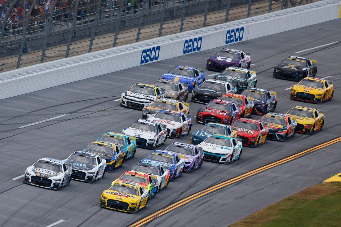 Oct 1, 2023; Talladega, Alabama, USA; NASCAR Cup Series driver Ryan Blaney (12) leads the pack to the finish line to win the YellaWood 500 at Talladega Superspeedway. Mandatory Credit: Douglas DeFelice-USA TODAY Sports