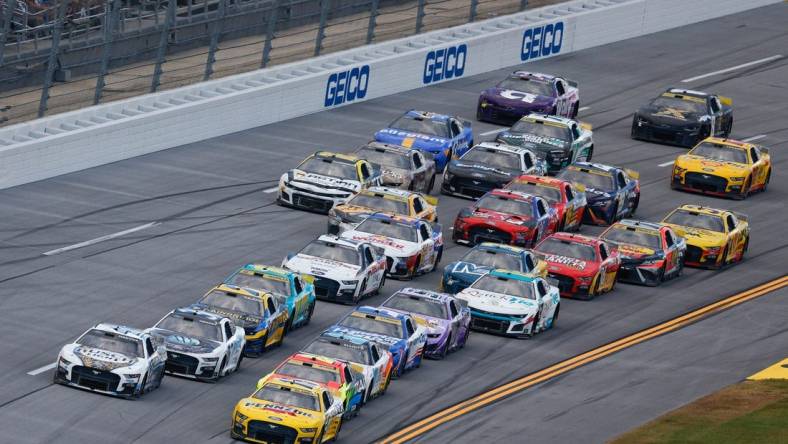 Oct 1, 2023; Talladega, Alabama, USA; NASCAR Cup Series driver Ryan Blaney (12) leads the pack to the finish line to win the YellaWood 500 at Talladega Superspeedway. Mandatory Credit: Douglas DeFelice-USA TODAY Sports