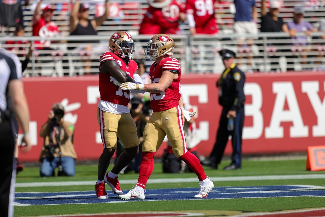 Oct 1, 2023; Santa Clara, California, USA; San Francisco 49ers running back Christian McCaffrey (23) celebrates with wide receiver Deebo Samuel (19) after a scoring a touchdown during the second quarter against the Arizona Cardinals at Levi's Stadium. Mandatory Credit: Sergio Estrada-USA TODAY Sports