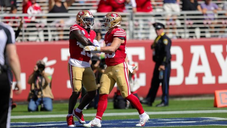 Oct 1, 2023; Santa Clara, California, USA; San Francisco 49ers running back Christian McCaffrey (23) celebrates with wide receiver Deebo Samuel (19) after a scoring a touchdown during the second quarter against the Arizona Cardinals at Levi's Stadium. Mandatory Credit: Sergio Estrada-USA TODAY Sports