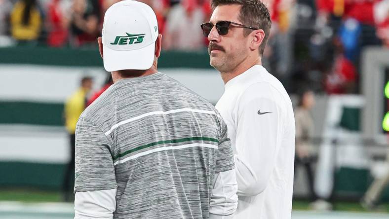 Oct 1, 2023; East Rutherford, New Jersey, USA; New York Jets quarterback Aaron Rodgers (8) talks with a member of the Jets staff before the game against the Kansas City Chiefs at MetLife Stadium. Mandatory Credit: Vincent Carchietta-USA TODAY Sports