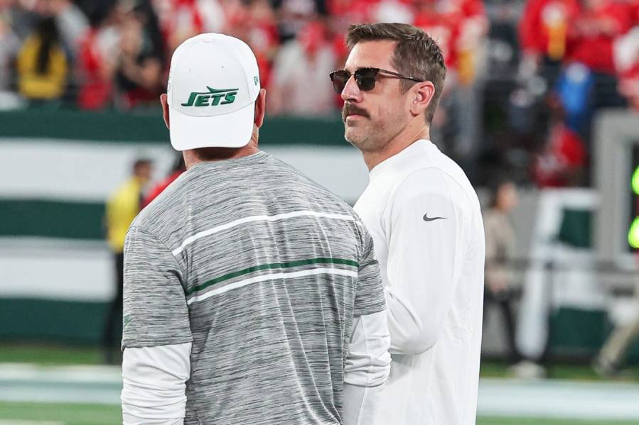 Oct 1, 2023; East Rutherford, New Jersey, USA; New York Jets quarterback Aaron Rodgers (8) talks with a member of the Jets staff before the game against the Kansas City Chiefs at MetLife Stadium. Mandatory Credit: Vincent Carchietta-USA TODAY Sports