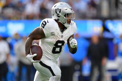 Oct 1, 2023; Inglewood, California, USA; Las Vegas Raiders running back Josh Jacobs (8) runs the ball against the Los Angeles Chargers during the second half at SoFi Stadium. Mandatory Credit: Gary A. Vasquez-USA TODAY Sports