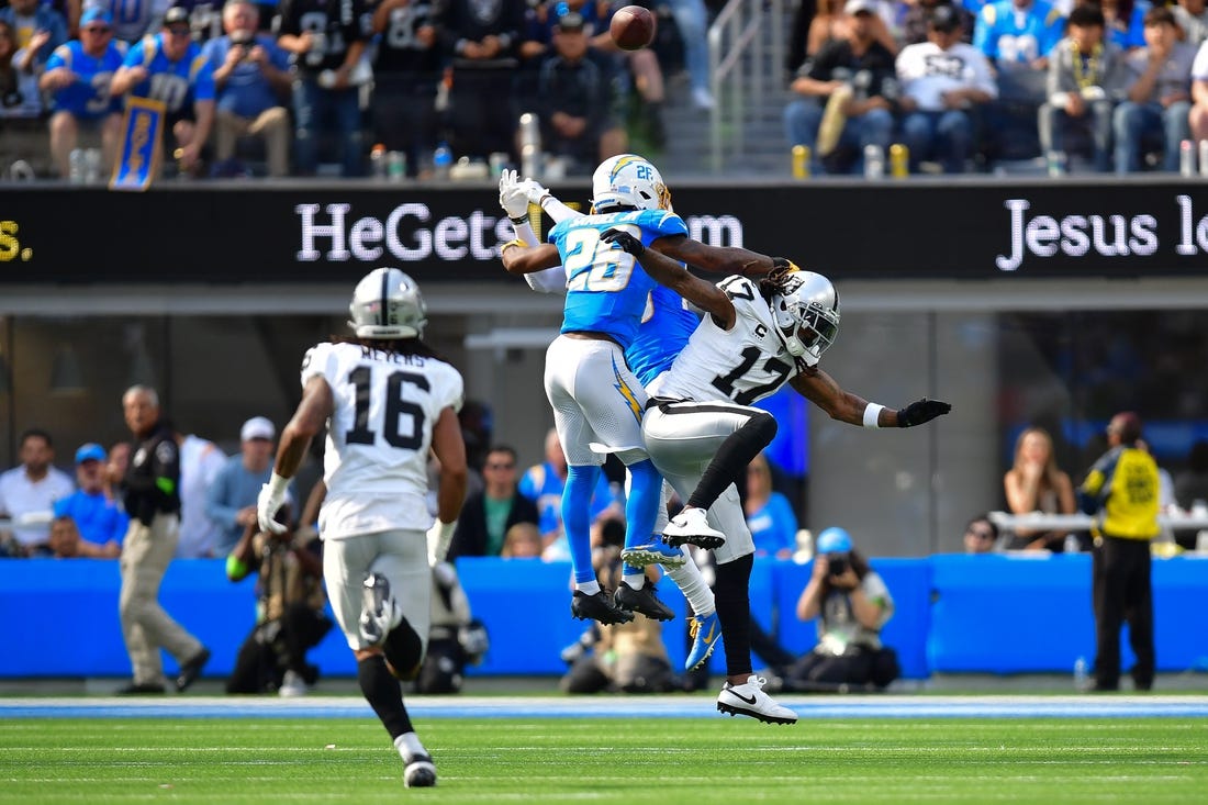 Oct 1, 2023; Inglewood, California, USA; Los Angeles Chargers cornerback Asante Samuel Jr. (26) blocks a pass intended for Las Vegas Raiders wide receiver Davante Adams (17) during the second half at SoFi Stadium. Mandatory Credit: Gary A. Vasquez-USA TODAY Sports