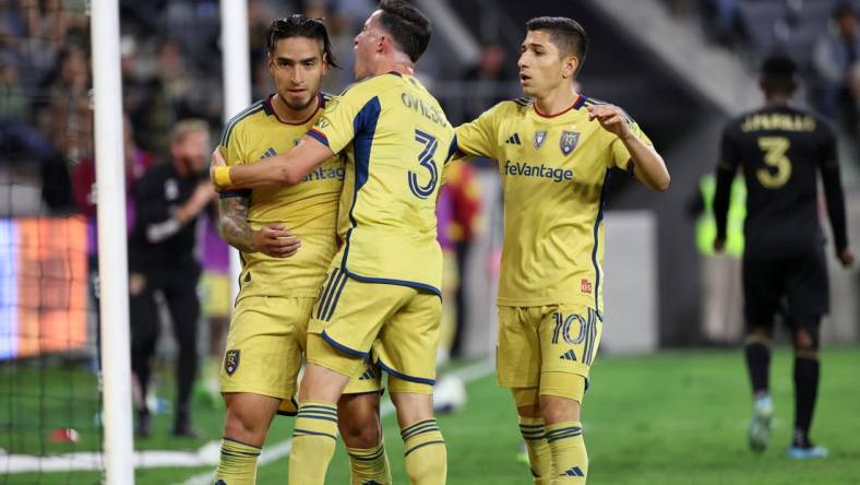 Oct 1, 2023; Los Angeles, California, USA;  Real Salt Lake forward Cristian Arango (9) celebrates with defender Bryan Oviedo (3) and forward Jefferson Savarino (10) after scoring a goal during the second half against the Los Angeles FC at BMO Stadium. Mandatory Credit: Kiyoshi Mio-USA TODAY Sports