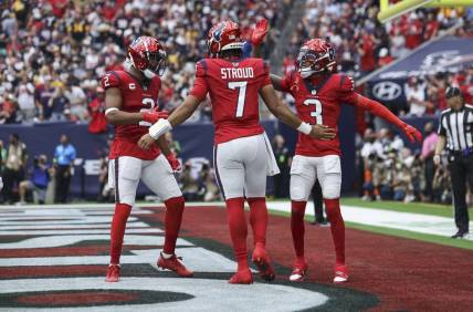 Houston Texans quarterback C.J. Stroud (7) celebrates with wide receiver Robert Woods (2) and wide receiver Tank Dell (3) after a touchdown during the game against the Pittsburgh Steelers at NRG Stadium. Mandatory Credit: Troy Taormina-USA TODAY Sports