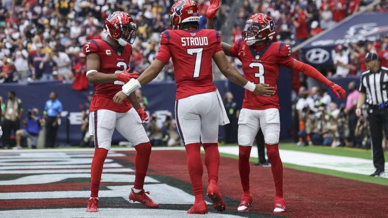 Houston Texans quarterback C.J. Stroud (7) celebrates with wide receiver Robert Woods (2) and wide receiver Tank Dell (3) after a touchdown during the game against the Pittsburgh Steelers at NRG Stadium. Mandatory Credit: Troy Taormina-USA TODAY Sports