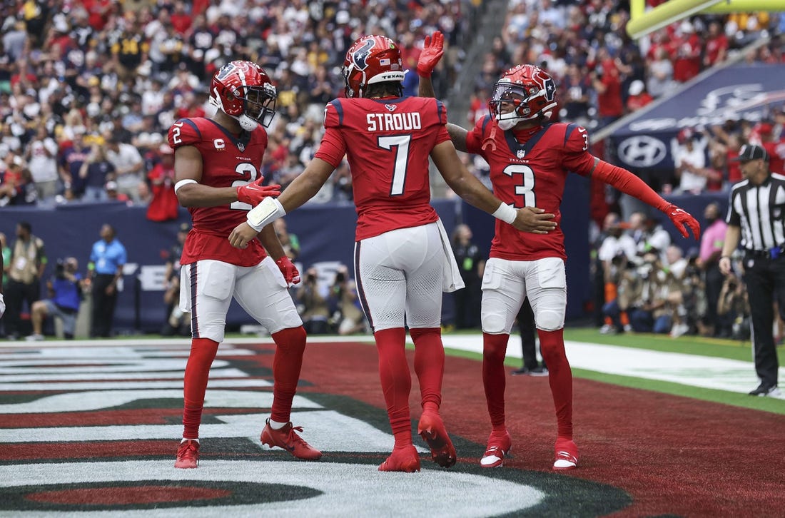 Houston Texans quarterback C.J. Stroud (7) celebrates with wide receiver Robert Woods (2) and wide receiver Tank Dell (3) after a touchdown during the game against the Pittsburgh Steelers at NRG Stadium. Mandatory Credit: Troy Taormina-USA TODAY Sports