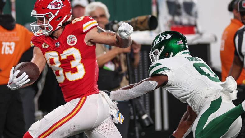 Oct 1, 2023; East Rutherford, New Jersey, USA; Kansas City Chiefs tight end Noah Gray (83) catches the ball for a touchdown pass against New York Jets safety Adrian Amos (0) during the first half at MetLife Stadium. Mandatory Credit: Vincent Carchietta-USA TODAY Sports