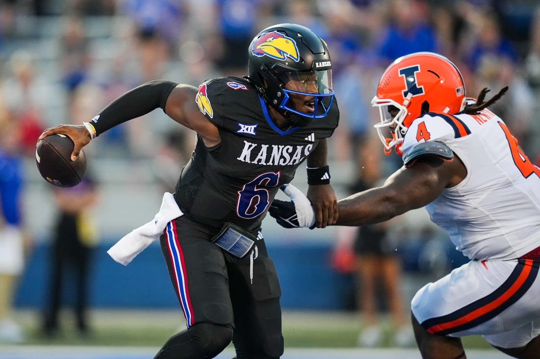 Sep 8, 2023; Lawrence, Kansas, USA; Kansas Jayhawks quarterback Jalon Daniels (6) against Illinois Fighting Illini defensive lineman Jer'Zhan Newton (4) during the first half at David Booth Kansas Memorial Stadium. Mandatory Credit: Jay Biggerstaff-USA TODAY Sports