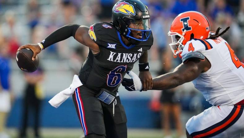 Sep 8, 2023; Lawrence, Kansas, USA; Kansas Jayhawks quarterback Jalon Daniels (6) against Illinois Fighting Illini defensive lineman Jer'Zhan Newton (4) during the first half at David Booth Kansas Memorial Stadium. Mandatory Credit: Jay Biggerstaff-USA TODAY Sports